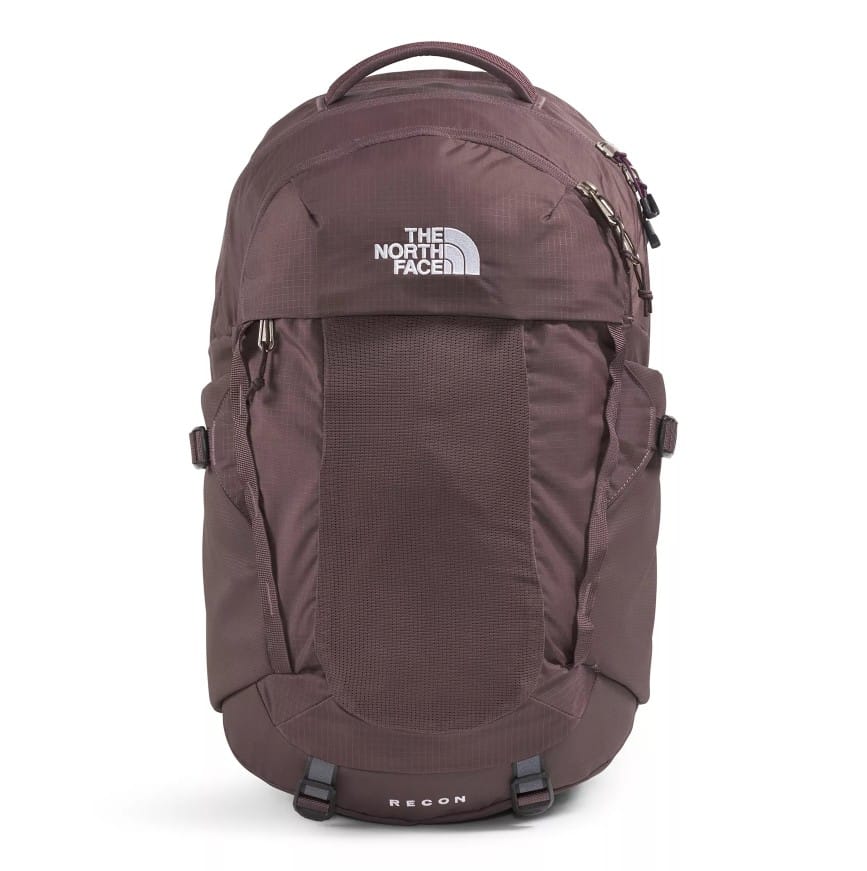 The photo shows a maroon backpack from The North Face, featuring multiple compartments and a top handle. The word \“RECON\“ is visible on the lower part.