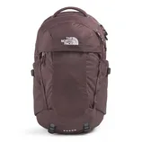 The photo shows a maroon backpack from The North Face, featuring multiple compartments and a top handle. The word \“RECON\“ is visible on the lower part.