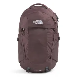 The photo shows a maroon backpack from The North Face, featuring multiple compartments and a top handle. The word \“RECON\“ is visible on the lower part.
