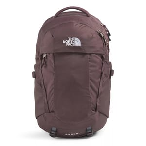 The photo shows a maroon backpack from The North Face, featuring multiple compartments and a top handle. The word \“RECON\“ is visible on the lower part.