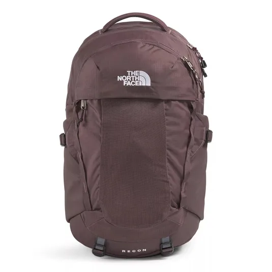 The photo shows a maroon backpack from The North Face, featuring multiple compartments and a top handle. The word \“RECON\“ is visible on the lower part.