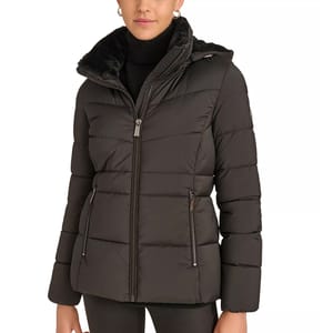 A woman's black puffer jacket with a hood, featuring a high collar, front zipper closure, and zippered side pockets. The interior appears to have a faux fur lining.