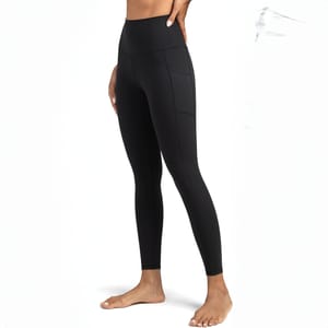 Black high-rise leggings with side pockets, reaching down to the ankles, shown on a person in a standing position.