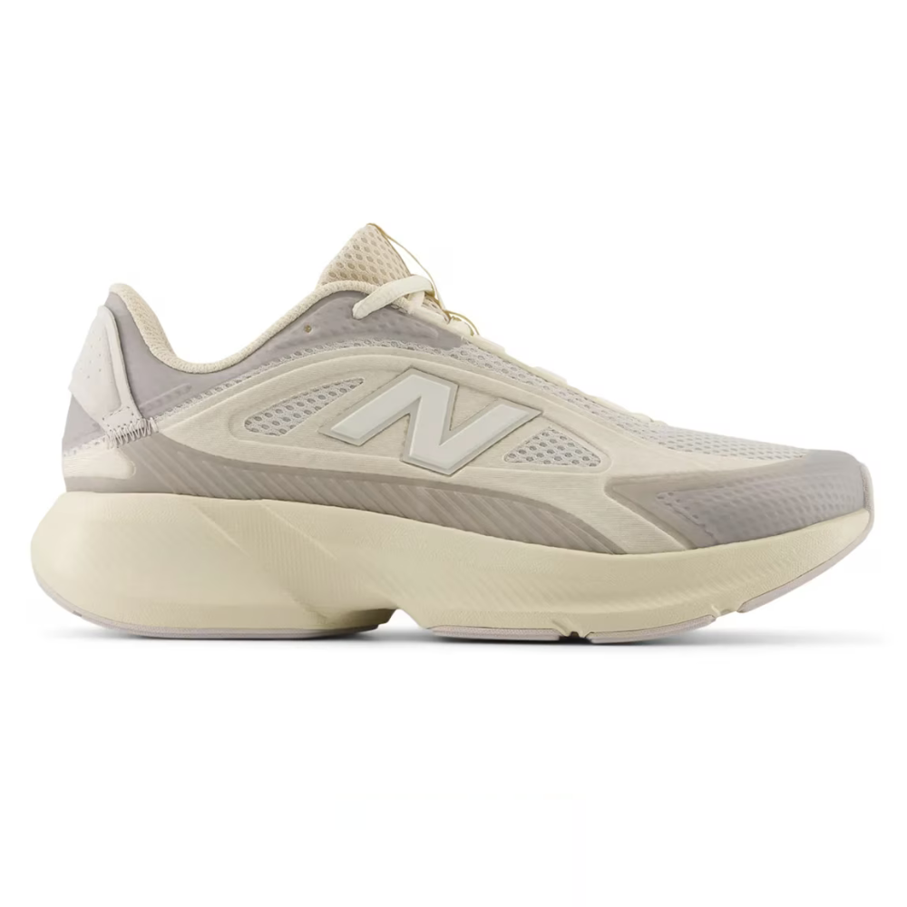 New Balance running shoe with a beige and gray color scheme, featuring a mesh upper and cushioned sole for comfort and support.