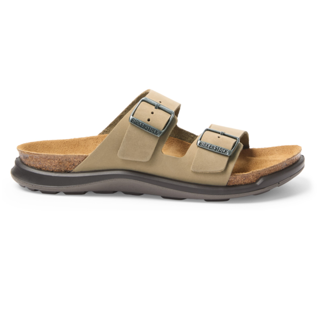 A Birkenstock sandal featuring two adjustable straps with buckles, a cork footbed, and a rubber sole, designed for comfort and support.