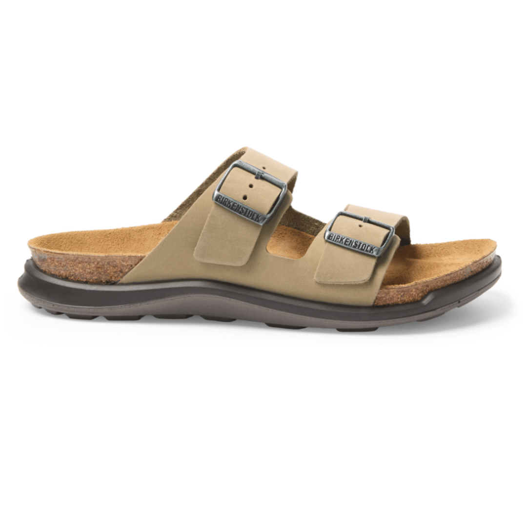 A Birkenstock sandal featuring two adjustable straps with buckles, a cork footbed, and a rubber sole, designed for comfort and support.