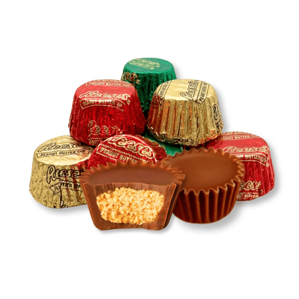 Reese's Peanut Butter Cups wrapped in red, gold, and green foil, with one cut open to show the peanut butter filling.
