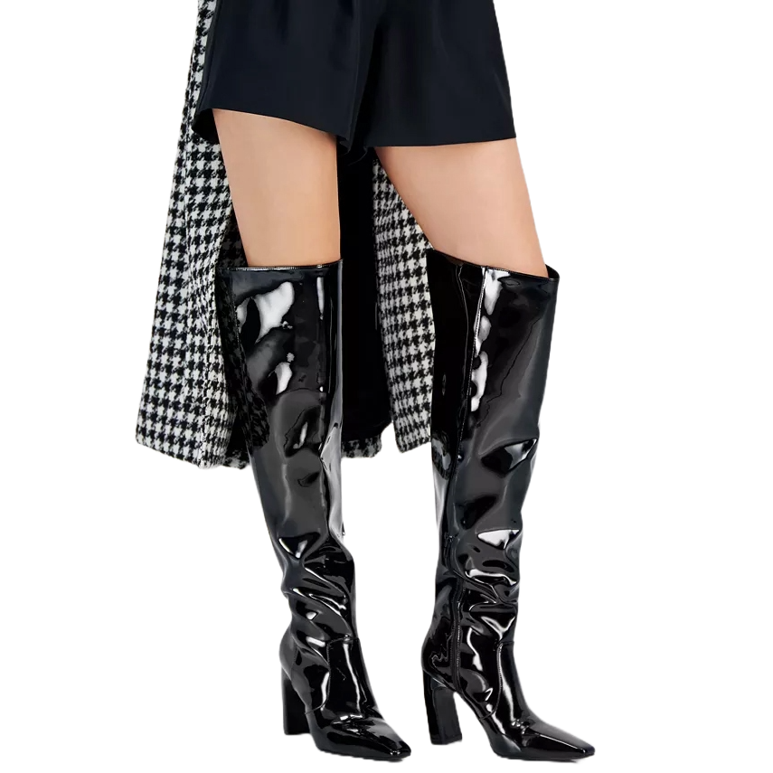 Black patent knee-high boots with block heels, styled with black shorts and a houndstooth-patterned coat.