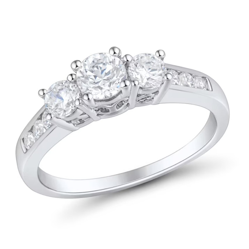 A white gold ring featuring three round-cut diamonds in the center, flanked by smaller diamonds embedded into the band.