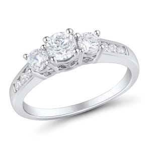 A white gold ring featuring three round-cut diamonds in the center, flanked by smaller diamonds embedded into the band.