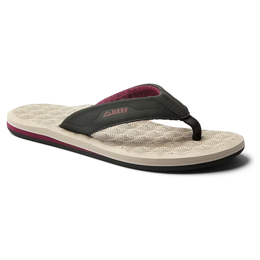 Reef flip-flop sandal with a beige textured sole, black strap, and red interior lining.