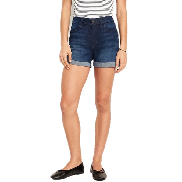 Woman wearing rolled-cuff denim shorts and a striped top, paired with black flats.