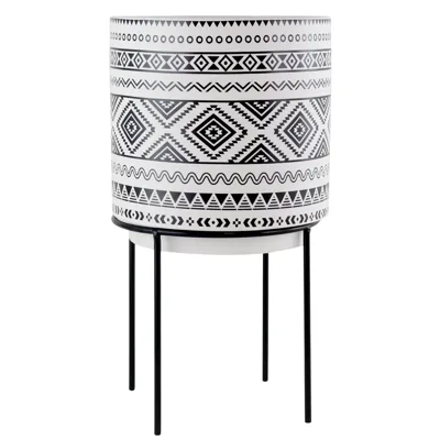 Black and white planter with geometric patterns on a metal stand.