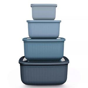 A set of four nesting blue storage containers with lids, each container slightly larger than the one above it, designed for space-saving organization.