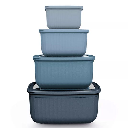 A set of four nesting blue storage containers with lids, each container slightly larger than the one above it, designed for space-saving organization.