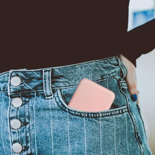 A pink portable hard drive peeks out of the back pocket of high-waisted, striped denim jeans with metallic buttons.