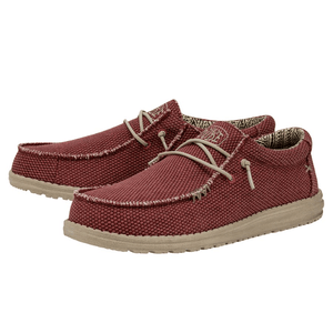 A pair of casual low-top lace-up shoes with a textured maroon fabric, beige lining, and light beige soles.