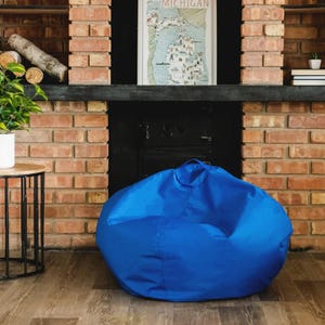 A blue bean bag chair in a room with a fireplace and a decorative Michigan map on the wall.