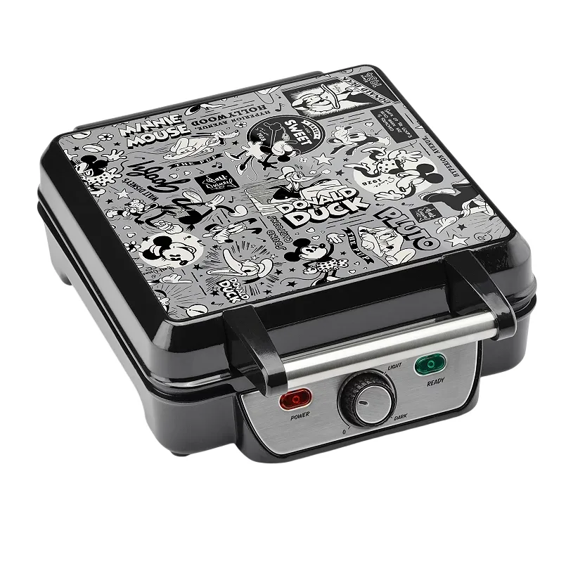 A waffle maker featuring classic Disney characters like Mickey Mouse, Minnie Mouse, Donald Duck, and Pluto in a black and white comic strip design with a power and ready indicator and browning control dial.