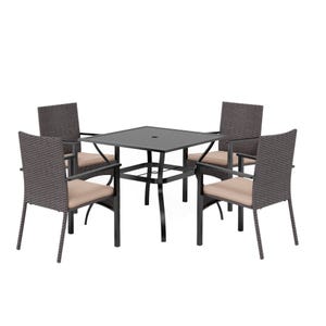 Outdoor dining set with a square table and four wicker chairs featuring beige cushions. The table has a central hole for an umbrella.