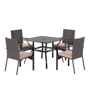 Outdoor dining set with a square table and four wicker chairs featuring beige cushions. The table has a central hole for an umbrella.