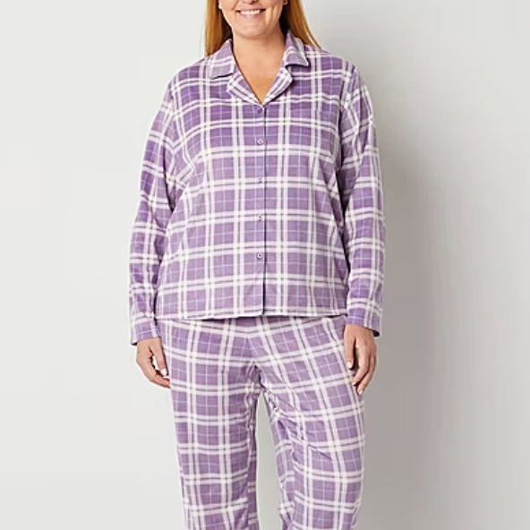 A woman wearing a purple and white plaid pajama set.