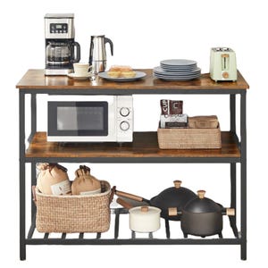 Kitchen shelf with a coffee maker, kettle, plates, toaster, microwave, and a basket of coffee supplies on the top two levels. Bottom shelf holds a basket with bags and three cookware pots.