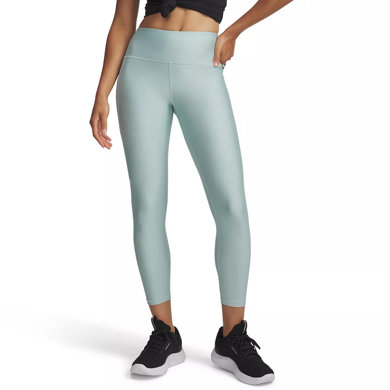 A model wears light blue high-waisted ankle-length leggings paired with black athletic shoes.