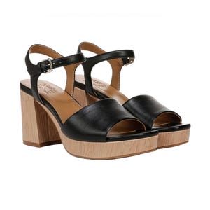 Black block-heel sandals with a wood-textured platform, featuring an open-toe design and adjustable ankle straps with buckles.
