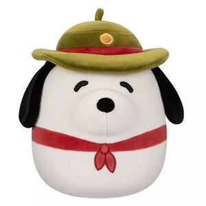 A Beagle Scout Snoopy Squishmallow, featuring a white plush dog with black ears, wearing a green scout hat and a red neckerchief, designed for cuddling and collecting.