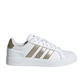 White Adidas sneaker with gold stripes and details, featuring a lace-up design and a low-profile sole.