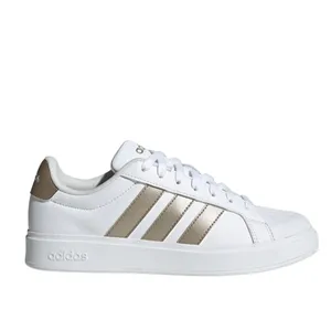 White Adidas sneaker with gold stripes and details, featuring a lace-up design and a low-profile sole.