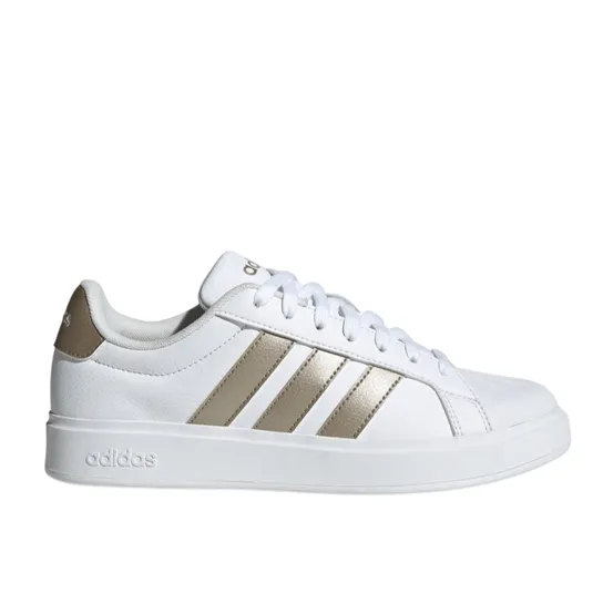 White Adidas sneaker with gold stripes and details, featuring a lace-up design and a low-profile sole.