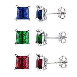 Three pairs of stud earrings with square-cut gemstones in blue, green, and red, set in silver prong settings.