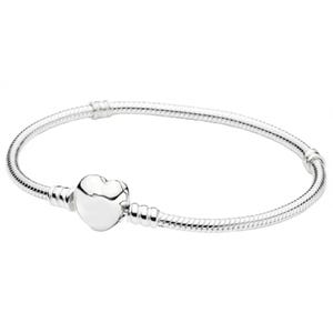 A silver bracelet with a snake chain design features a heart-shaped clasp.