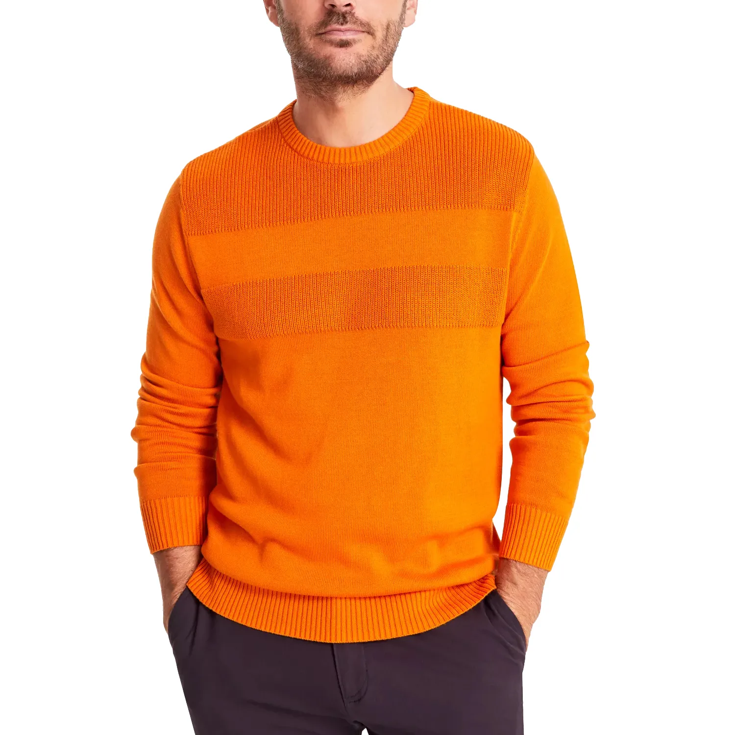 Orange ribbed sweater with textured horizontal bands, worn with dark pants. Hands are in the pockets, and the sweater has a crew neck with ribbed cuffs and hem.