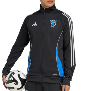 A person wearing a black Adidas track jacket with blue accents and white stripes is holding a soccer ball. The jacket features an \“AEROREADY\“ label and a logo on the chest.