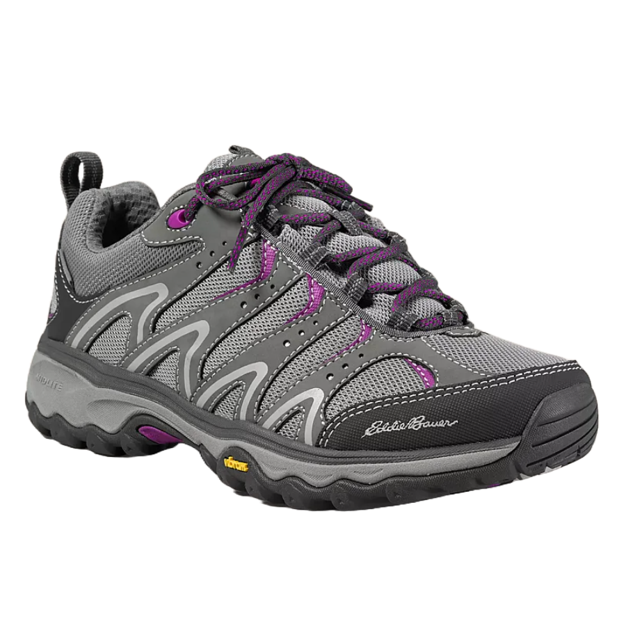 Eddie Bauer waterproof hiking shoes feature a gray and purple design with durable mesh, reinforced toe cap, and padded collar. They have textured outsoles for grip and a logo on the side.
