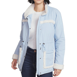 Light blue jacket with white sherpa trim on the collar, cuffs, and pockets, featuring a drawstring waist and snap-button details, worn over a white shirt and paired with dark jeans.