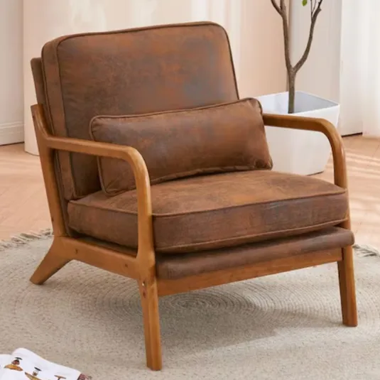 A brown armchair with a wooden frame and a matching lumbar cushion is placed on a light-colored circular rug.