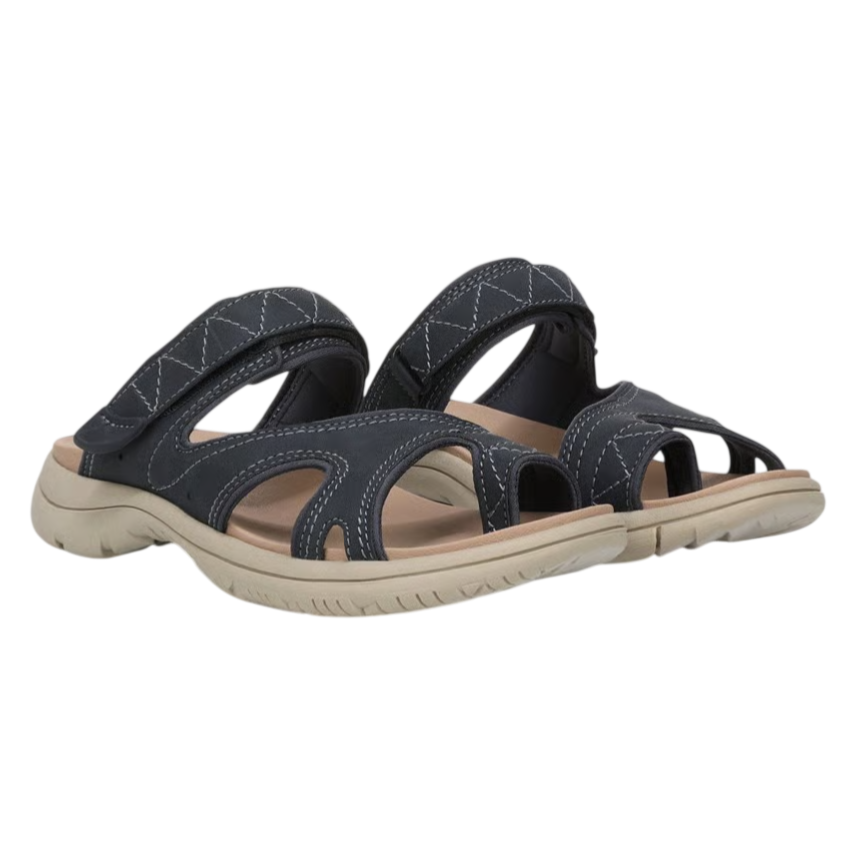 A pair of navy-blue casual slip-on sandals with cut-out patterns and beige soles, featuring contrast stitching and comfortable arch support.