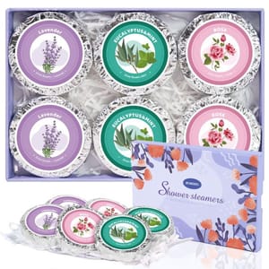 Set of six shower steamers in a box with lavender, eucalyptus & mint, and rose scents. Each steamer is foil-wrapped and labeled with corresponding illustrations for easy identification.