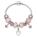 A silver charm bracelet features pink heart-shaped charms and beads, adorned with sparkling details and a prominent dangling heart charm.