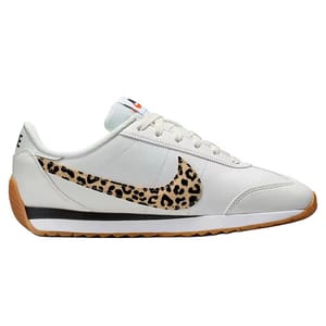 White athletic shoe with a leopard print Nike swoosh and a gum sole.