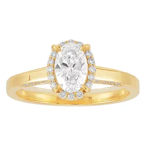 A gold ring featuring an oval-cut diamond center stone, surrounded by a halo of smaller diamonds, with additional diamonds set along the band.