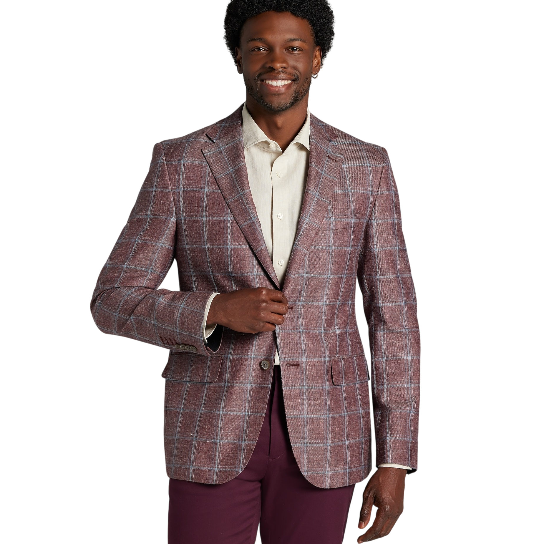 A man wearing a plaid blazer over a light-colored dress shirt, paired with dark maroon pants, poses with a slight smile against a plain backdrop.