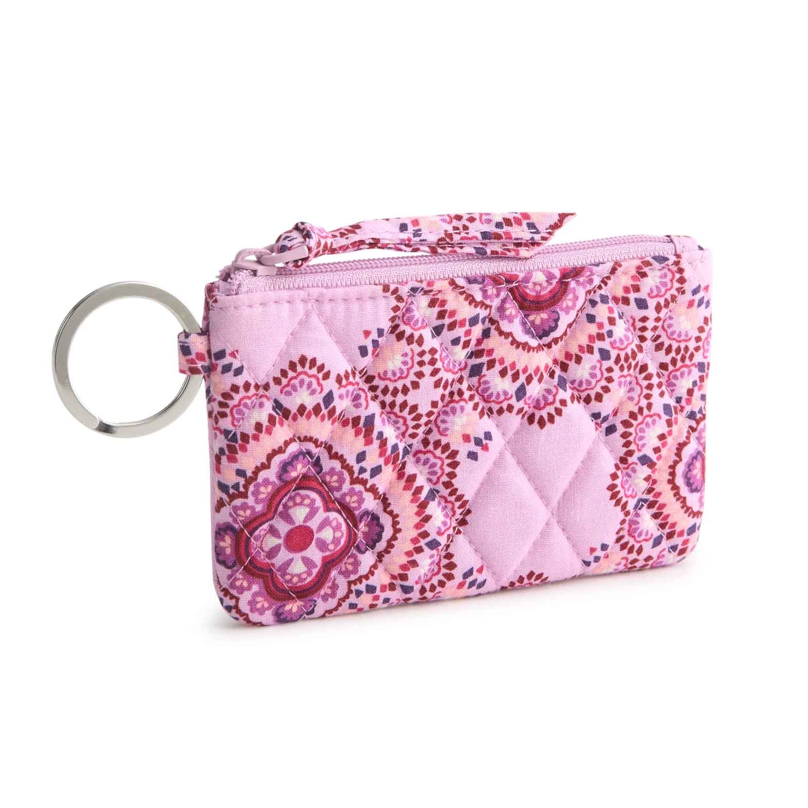 Quilted pink coin purse with floral patterns, zipper closure, and metal key ring attachment.