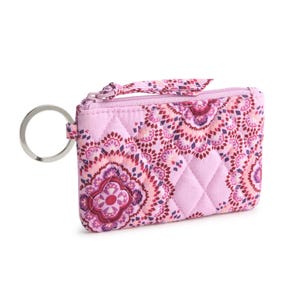 Quilted pink coin purse with floral patterns, zipper closure, and metal key ring attachment.