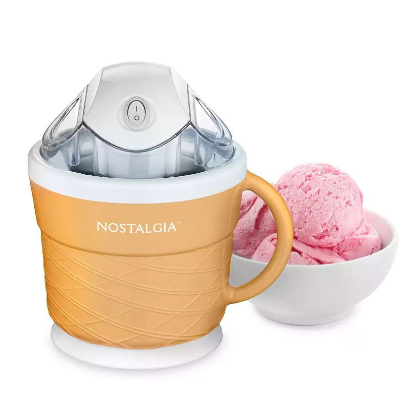 Nostalgia ice cream maker in a cone-shaped design, accompanied by a bowl of pink ice cream scoops.