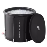 A cylindrical black ice bath with the \“Sharper Image\“ logo, filled with ice, includes a removable lid.